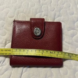 Red leather wallet. accent to any larger handbag. Lots of card slots.